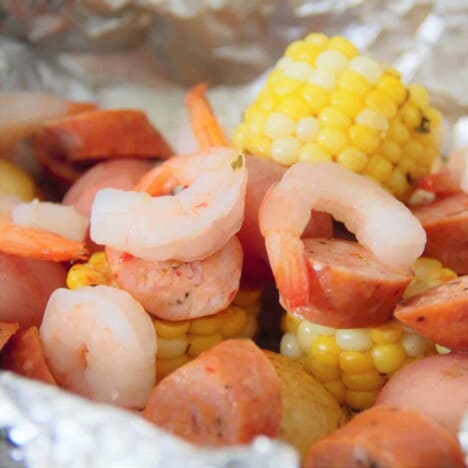 Shrimp, andouille sausage, baby red potatoes, and slices of corn in foil.