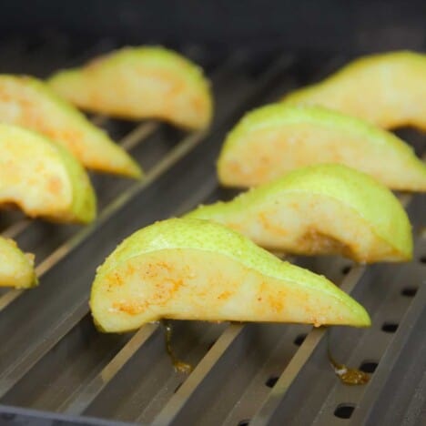 Fresh pear quarters just added to hot Grillgrates.