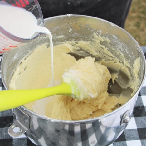 Milk being poured into a forming cake batter.