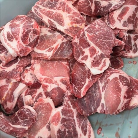 Pork is prepare into 1-inch slices and placed in a bowl.