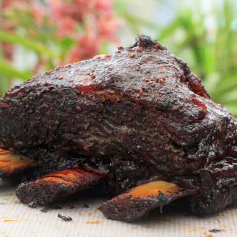 A close up of smoked beef short ribs with a dark crust.