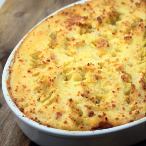 Looking down on a casserole dish of golden brown mashed potatoes.