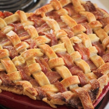 A golden brown pie lattice made of pastry and bacon.