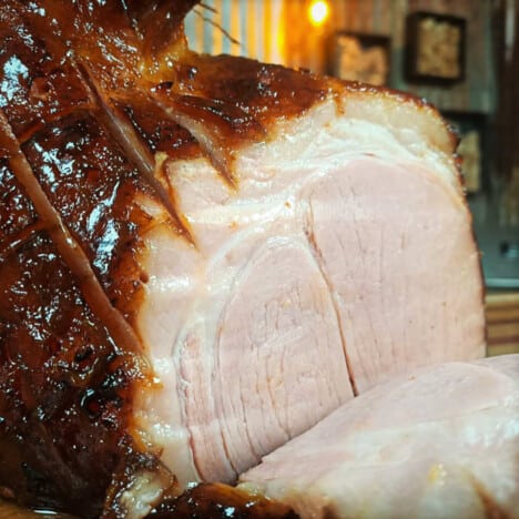 Smoked ham being sliced after cooking