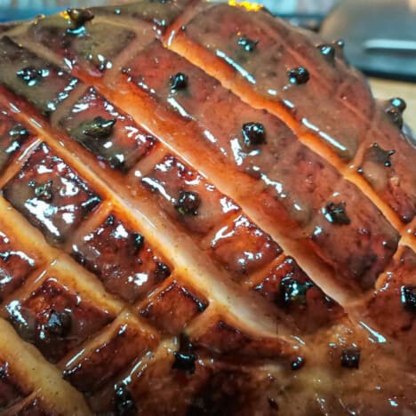 Close up of the glaze on a criss cut ham with cloves in each dimond.