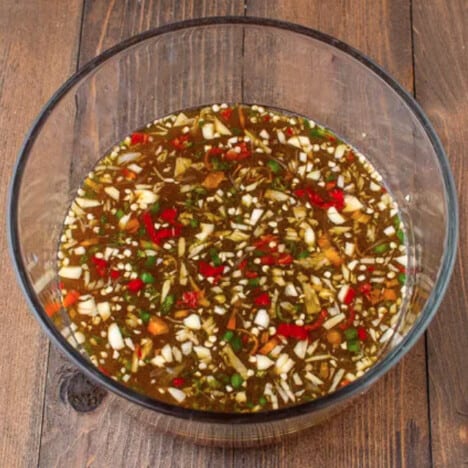 Looking into a glass bowl with the marinade ingredients.