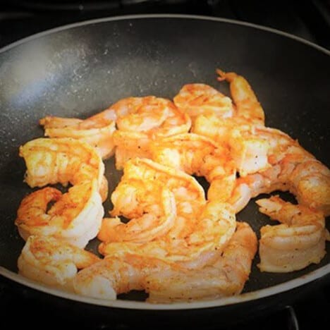 Shrimp being cooked in a frypan.